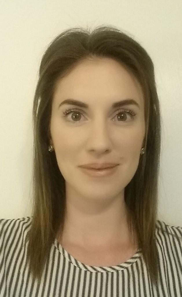 A woman with long hair and brown eyes.