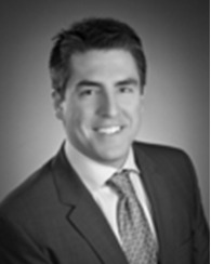 A black and white photo of a man in suit